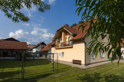 a house with a fence and a goal at Apartments Leonid in Podčetrtek