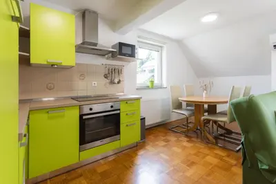a kitchen with lime green cabinets and a table at Apartments Leonid in Podčetrtek