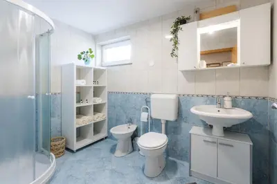 a bathroom with a toilet and a sink at Apartments Leonid in Podčetrtek