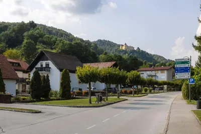 a street in a town with a mountain at Apartments Leonid in Podčetrtek