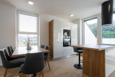 a kitchen and dining room with a table and chairs at Apartment Dalgona Delux in Podčetrtek