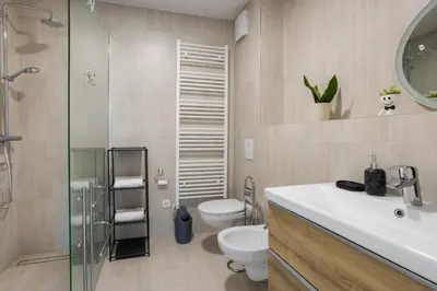 a bathroom with a toilet and a sink and a shower at Apartment Dalgona Delux in Podčetrtek