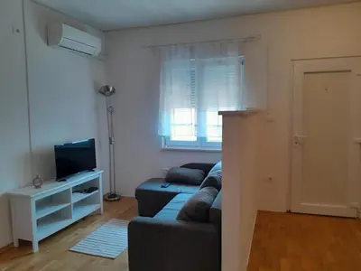 a living room with a couch and a television at apartma pika 2 in Nova Gorica