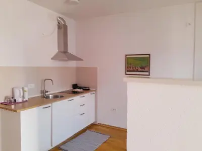 a kitchen with white cabinets and a sink at apartma pika 2 in Nova Gorica