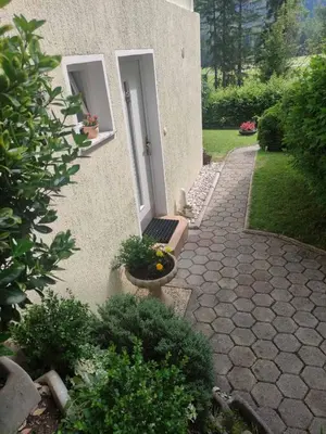 a walkway leading to a door of a house at Bungalov in Gozd Martuljek