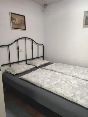 two beds sitting next to each other in a bedroom at Bungalov in Gozd Martuljek