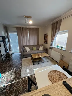 a living room with a couch and a table at CentralPark Suites in Maribor