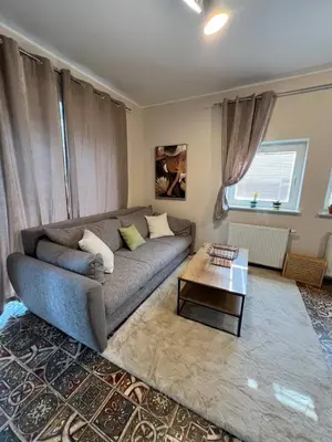 a living room with a couch and a coffee table at CentralPark Suites in Maribor