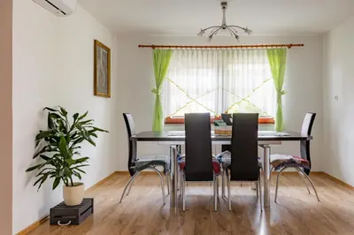 a dining room with a table and chairs at Apartma PRI AJHECI in Pristava pri Mestinju