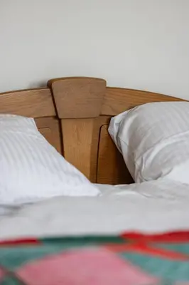 a close up of a bed with white sheets and pillows at Apartma PRI AJHECI in Pristava pri Mestinju
