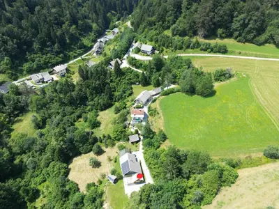 an aerial view of a farm with houses and trees at Honey house in Zgornje Gorje