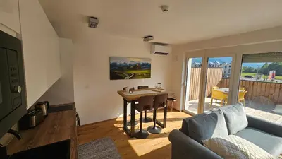 a living room with a couch and a table at Apartment 1 Pearl in Bovec