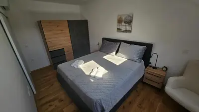 a bedroom with a bed with two towels on it at Apartment 1 Pearl in Bovec