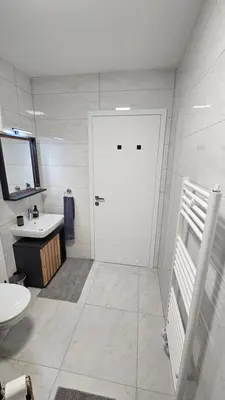 a bathroom with a white door and a sink at Apartment 1 Pearl in Bovec