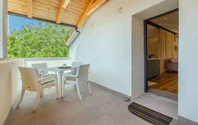 a dining room with a table and chairs and a window at Apartmaji Robida in Sežana