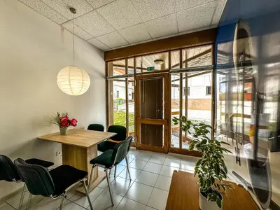 a dining room with a table and green chairs at Apartmaji Vogelnik in Radovljica