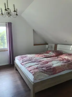 a bedroom with a bed in a room with a window at Apartmaji Vogelnik in Radovljica
