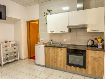 a kitchen with white cabinets and a sink at Apartmaji Vogelnik in Radovljica