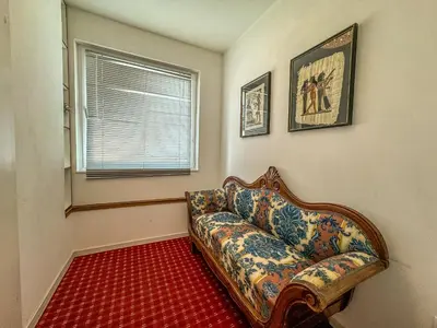 a living room with a couch and a window at Apartmaji Vogelnik in Radovljica