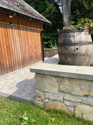 a large planter on a stone wall next to a fence at Maja's Sunrise Haven in Mala Nedelja