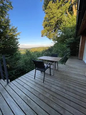 a wooden deck with a table and chairs on it at Maja's Sunrise Haven in Mala Nedelja