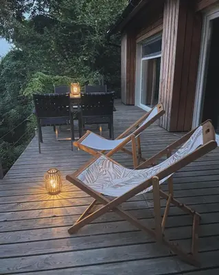 a couple of chairs sitting on a wooden deck at Maja's Sunrise Haven in Mala Nedelja