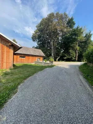 an empty road next to a barn at Maja's Sunrise Haven in Mala Nedelja