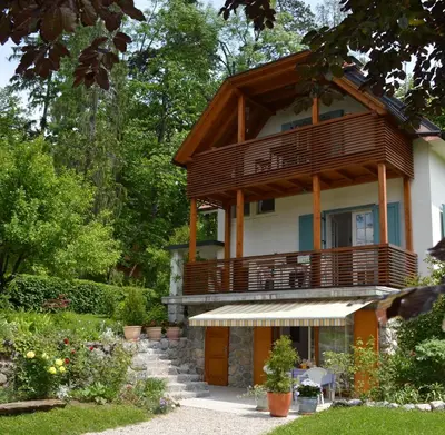 a house with a balcony on top of it at VILA BREDA in Bled center in Bled