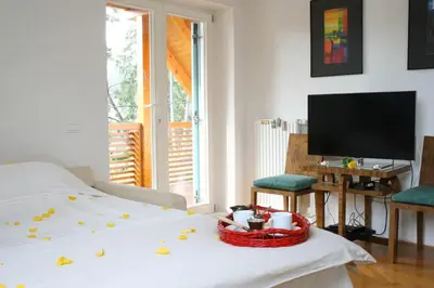 a living room with a bed with a basket on it at VILA BREDA in Bled center in Bled