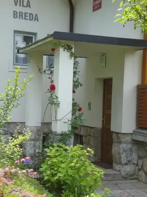 a building with a door and flowers in front of it at VILA BREDA in Bled center in Bled