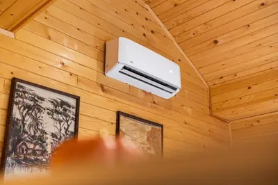 a wall mounted air conditioner on a wooden ceiling at Apartma Farm Bliss in Zgornja Velka
