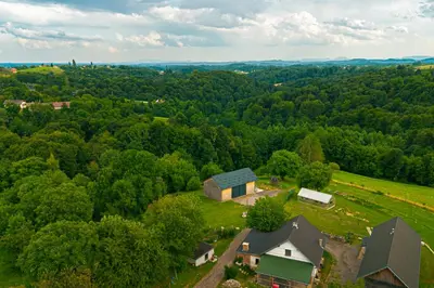 an aerial view of a house in the woods at Apartma Farm Bliss in Zgornja Velka