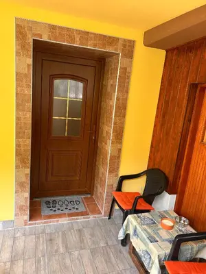 a room with a door and a table and a chair at Apartma Brin in Bovec