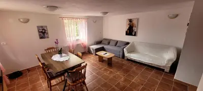 a living room with a couch and a table at Apartma Brin in Bovec