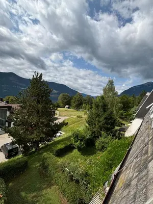 a view of a yard with a tree and mountains at Apartma Tine in Bovec