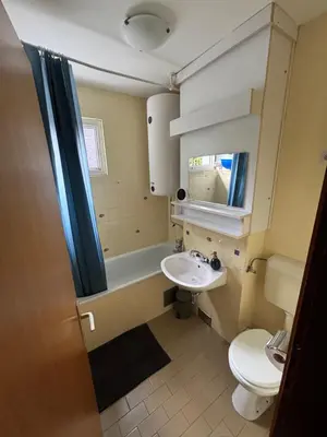 a small bathroom with a sink and a toilet at Apartma Tine in Bovec