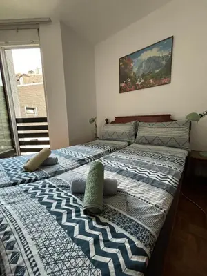 two twin beds in a room with a window at Apartma Tine in Bovec