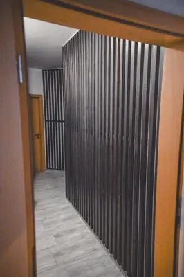 a hallway with a wooden wall and a door at Apartments & rooms Ksenya in Spodnja Hajdina