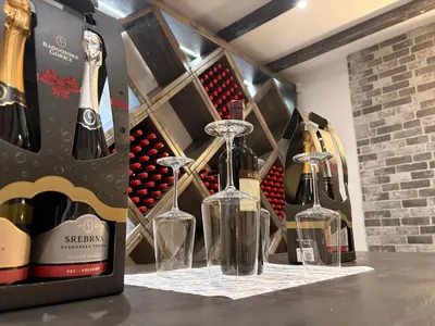 two wine bottles on a table in a wine cellar at Apartments & rooms Ksenya in Spodnja Hajdina