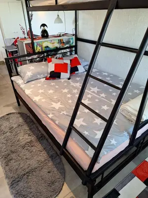 a bedroom with a bunk bed with a glass wall at Štibelc FRIDA in Izlake