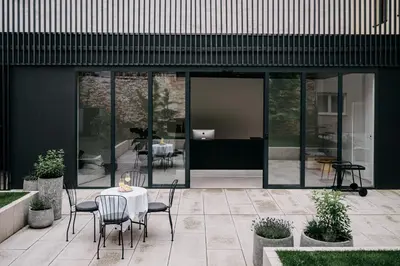 a patio with a table and chairs in front of a building at Villa Elizabeth - Mansard Apartment for 4 in Slovenj Gradec