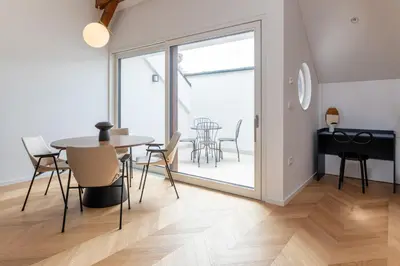 a dining room with a table and chairs and a patio at Villa Elizabeth - Mansard Apartment for 4 in Slovenj Gradec