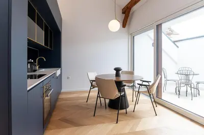 a kitchen and dining room with a table and chairs at Villa Elizabeth - Mansard Apartment for 4 in Slovenj Gradec