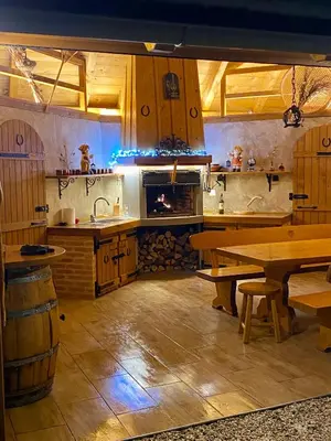a kitchen with a stove and a table and a fireplace at FAMILY HOUSE Pri Kovaču in Soča