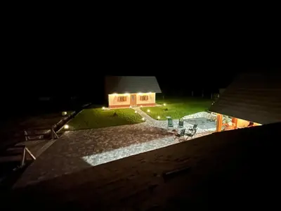 a view of a house at night at FAMILY HOUSE Pri Kovaču in Soča