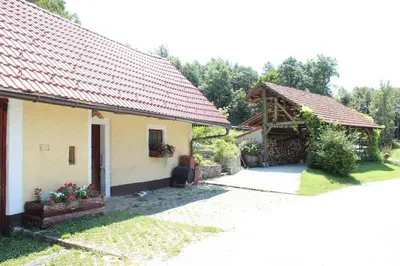 a house with a red roof and a courtyard at Na Gmajni pr' Angležu in Gabrovka