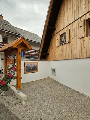 a building with a sign on the side of it at Apartma Pr'Komarjo in Zgornje Gorje