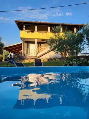 a house and a reflection in the water at Apartments Štrancar wines in Ajdovščina