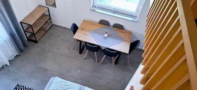 an overhead view of a wooden table and chairs at Apartments Štrancar wines in Ajdovščina