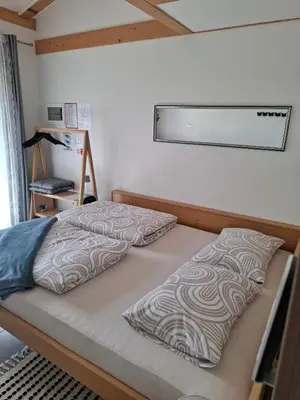 a bed in a bedroom with avertisementatronatronstrationstrationstration at Apartments Štrancar wines in Ajdovščina